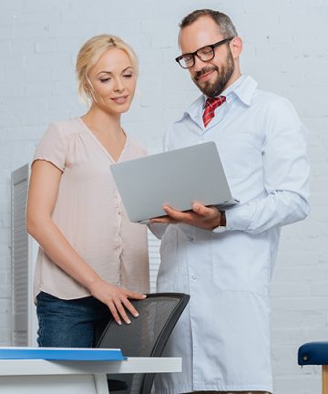 Chiropractor showing report of findings to a patient